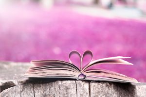 Book opened, centre pages folded to be a love heart in outline